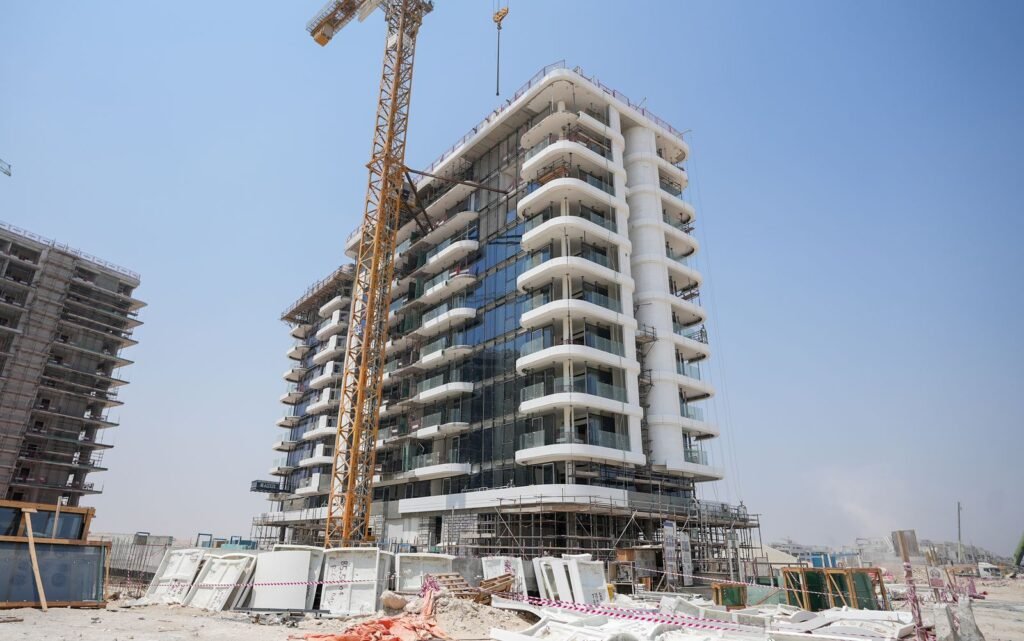 Azizi Venice tower with facade glazing in progress, September 2026